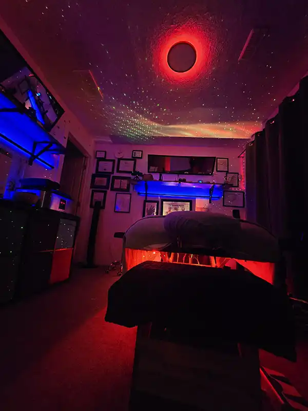 Massage therapy room with red lighting prepared for an individual massage session in Calgary SE